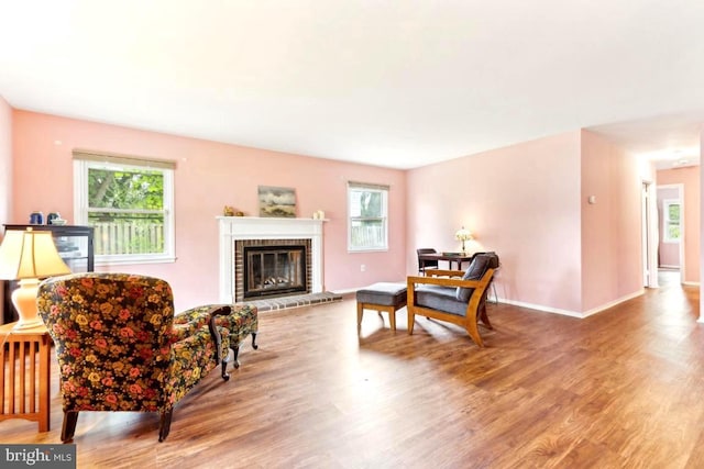 4105 Majestic Ln, Fairfax, VA 22033 - living area with wood finished floors, a brick fireplace, and baseboards