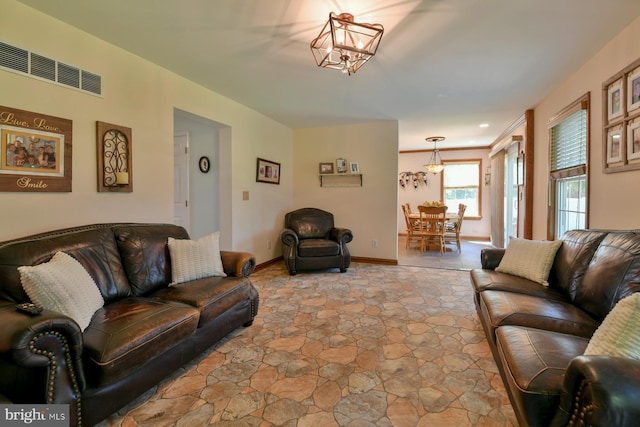 12 Ethan Ter, Woolwich Twp, NJ 08085 - living area featuring a chandelier and light stone finish floors