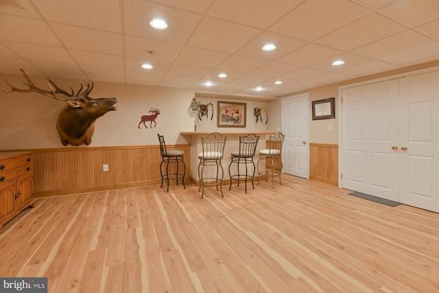 12 Ethan Ter, Woolwich Twp, NJ 08085 - bar with light wood finished floors, a wainscoted wall, baseboards, a drop ceiling, and wooden walls