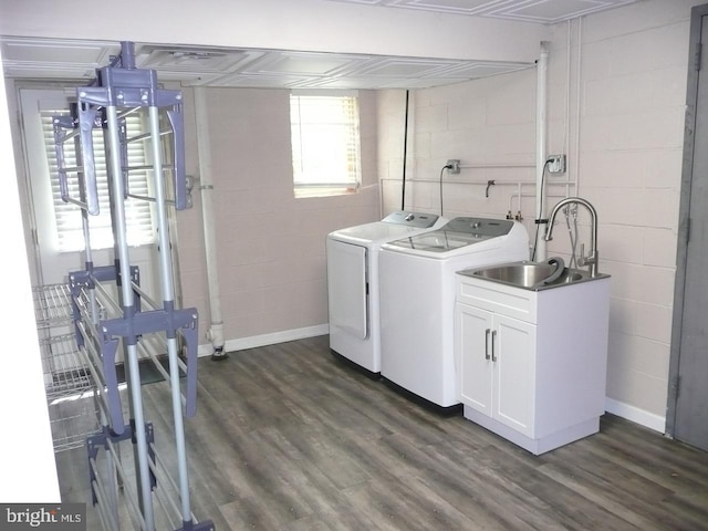 2602 Avenue E Ave E, Levittown, PA 19056 - washroom featuring independent washer and dryer, concrete block wall, dark wood-style flooring, cabinet space, and baseboards