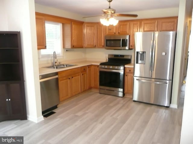 2602 Avenue E Ave E, Levittown, PA 19056 - kitchen featuring stainless steel appliances, a sink, light wood finished floors, light countertops, and ceiling fan