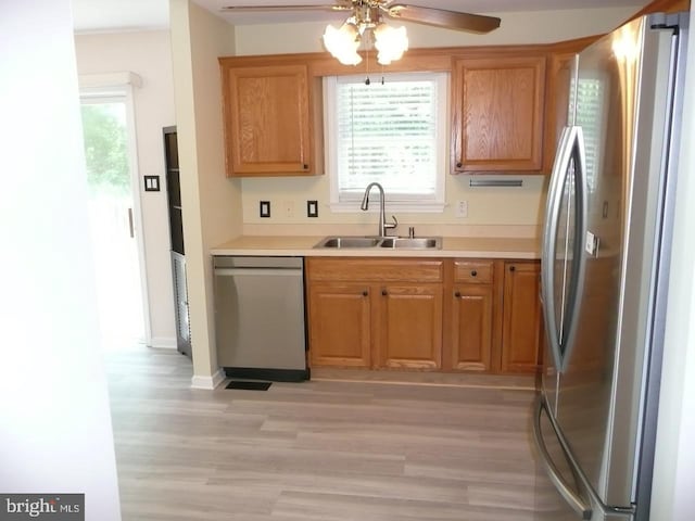 2602 Avenue E Ave E, Levittown, PA 19056 - kitchen featuring appliances with stainless steel finishes, a sink, light wood-style flooring, a ceiling fan, and light countertops