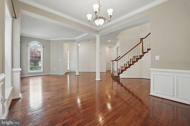 8313 Middle Ruddings Dr, Lorton, VA 22079 - unfurnished living room featuring ornate columns, wood-type flooring, stairway, a chandelier, and ornamental molding