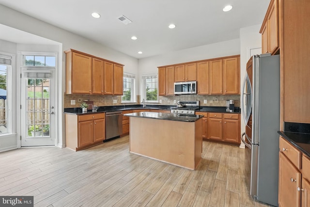 8313 Middle Ruddings Dr, Lorton, VA 22079 - kitchen with stainless steel appliances, plenty of natural light, a kitchen island, tasteful backsplash, and recessed lighting