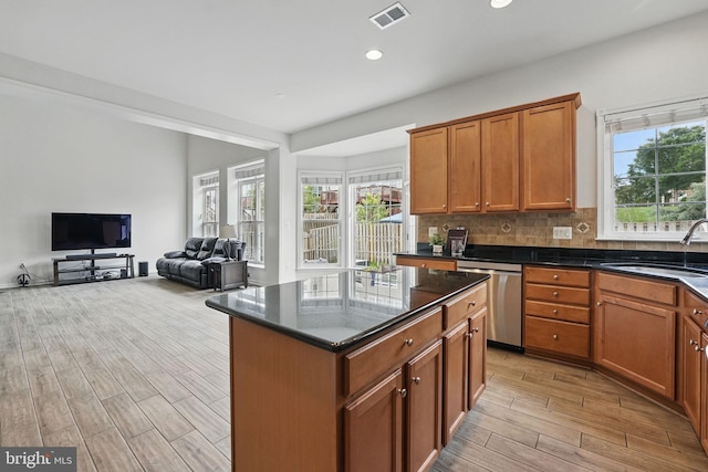 8313 Middle Ruddings Dr, Lorton, VA 22079 - kitchen with dishwasher, a sink, light wood-type flooring, backsplash, and brown cabinetry