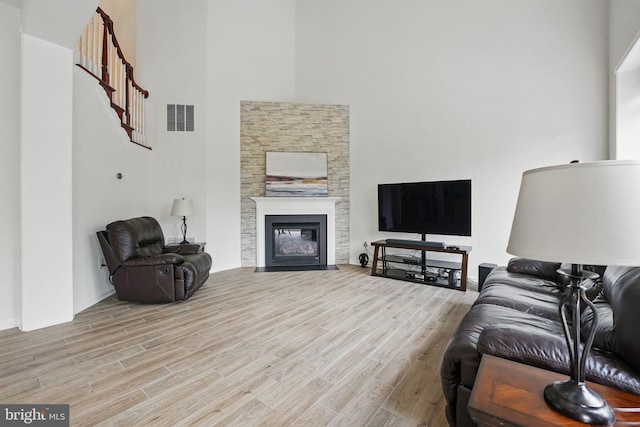 8313 Middle Ruddings Dr, Lorton, VA 22079 - living room featuring a high ceiling, wood finished floors, and a fireplace with flush hearth
