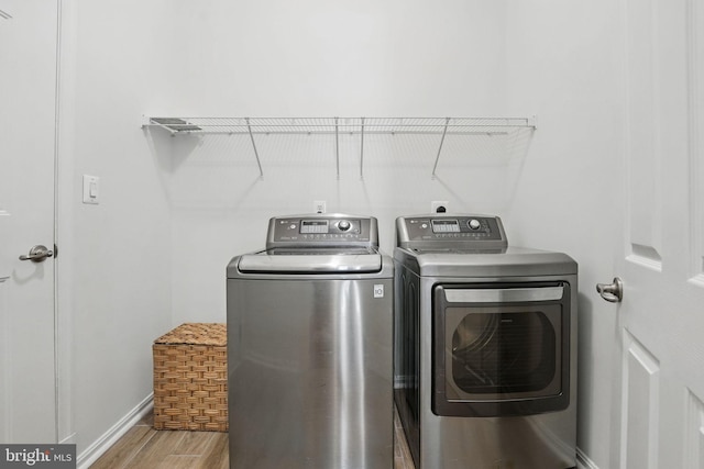 8313 Middle Ruddings Dr, Lorton, VA 22079 - laundry room featuring washer and clothes dryer, wood finished floors, and baseboards