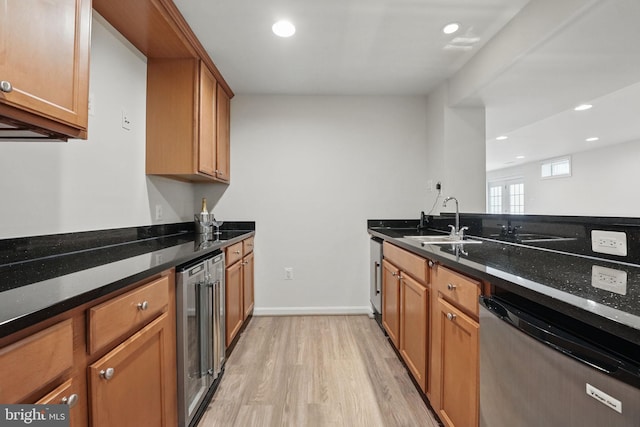 8313 Middle Ruddings Dr, Lorton, VA 22079 - kitchen featuring dishwashing machine, wine cooler, a sink, light wood-type flooring, and dark stone countertops