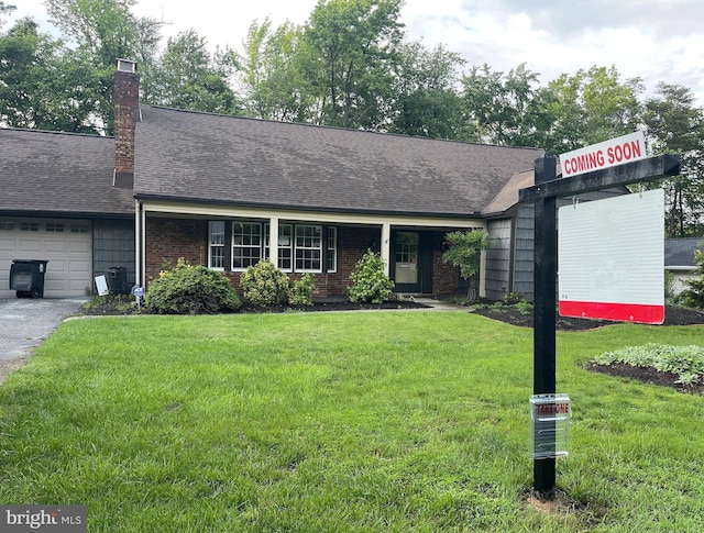 8906 Eastbourne Ln, Laurel, MD 20708 - view of front facade with an attached garage, a front lawn, a chimney, and roof with shingles