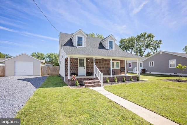 511 Goldsborough Ave, Cambridge, MD 21613 - new england style home with covered porch, driveway, brick siding, an outdoor structure, and a shingled roof