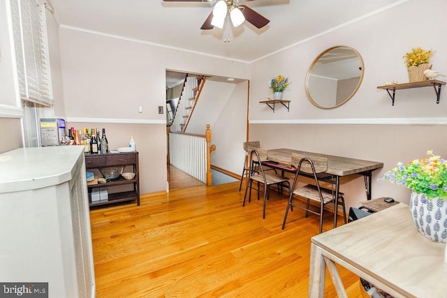 206 Mifflin St, Philadelphia, PA 19148 - dining room featuring a ceiling fan, light wood finished floors, stairway, and crown molding