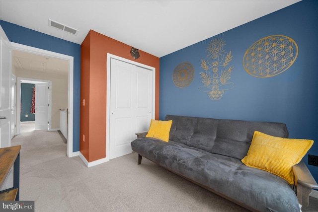 carpeted living area with baseboards