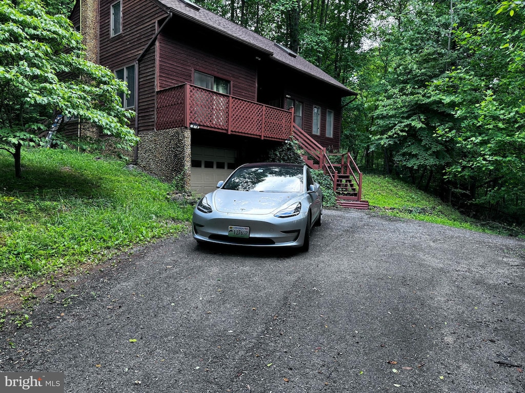 448 Newton Dr, Linden, VA 22642 - rustic home with an attached garage, stairs, asphalt driveway, roof with shingles, and stone siding