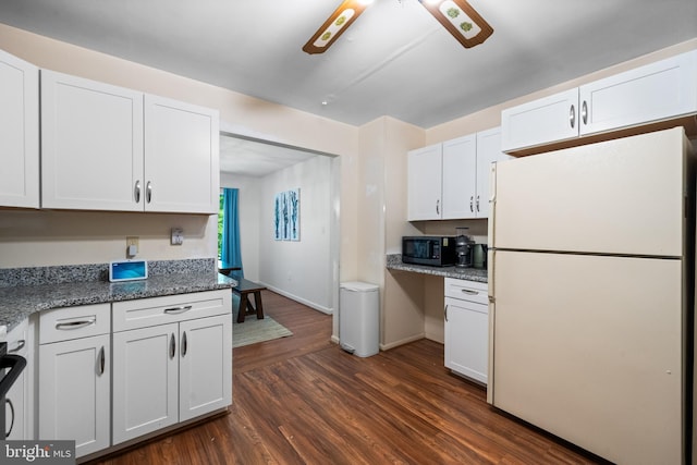 448 Newton Dr, Linden, VA 22642 - kitchen with freestanding refrigerator, black microwave, white cabinets, dark wood-style flooring, and baseboards