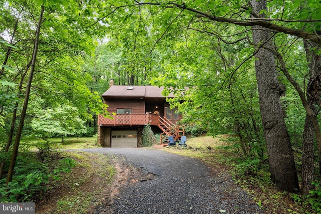 448 Newton Dr, Linden, VA 22642 - rustic home with asphalt driveway, stairs, a chimney, a garage, and a wooded view