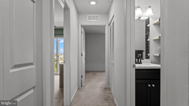 3073 Goshen Dr Unit M55L, Pennsburg, PA 18073 - hall featuring a sink, light colored carpet, and baseboards