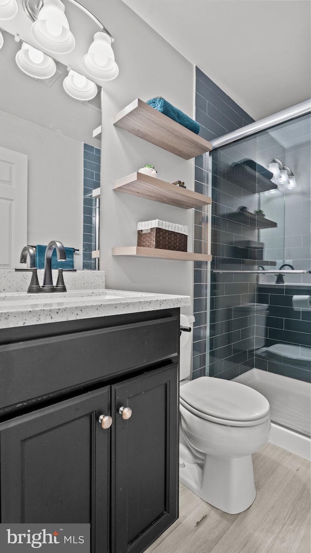 3073 Goshen Dr Unit M55L, Pennsburg, PA 18073 - bathroom featuring wood finished floors, a stall shower, toilet, and vanity