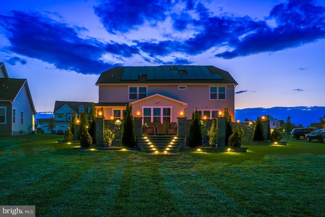 878 Sweet Birch Dr, Middletown, DE 19709 - rear view of house with solar panels and a lawn