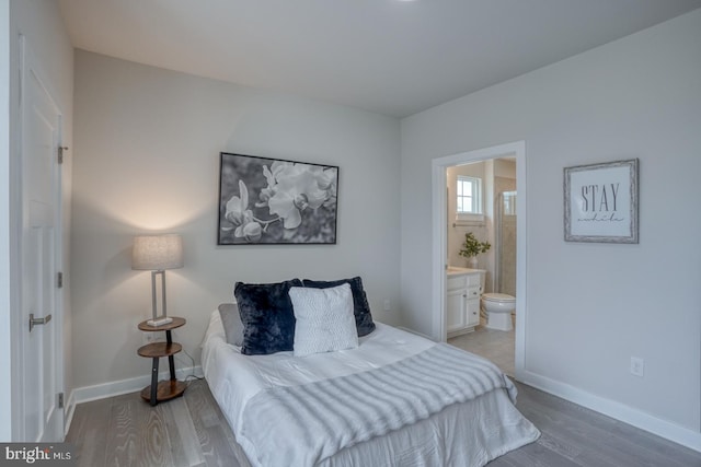 878 Sweet Birch Dr, Middletown, DE 19709 - bedroom featuring wood finished floors, connected bathroom, and baseboards