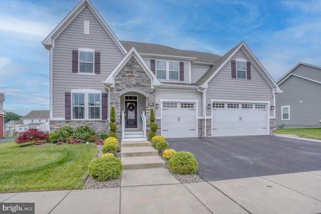 878 Sweet Birch Dr, Middletown, DE 19709 - view of front of house featuring stone siding, a garage, and asphalt driveway