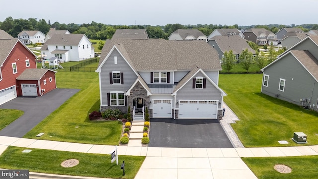 878 Sweet Birch Dr, Middletown, DE 19709 - view of front of home with stone siding, asphalt driveway, a residential view, and a front yard