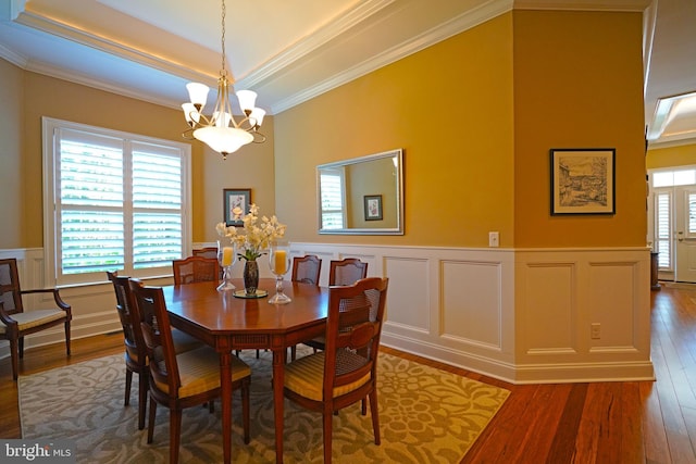 322 Captains Cir, Lewes, DE 19958 - dining space with a chandelier, wood finished floors, a wainscoted wall, ornamental molding, and a decorative wall