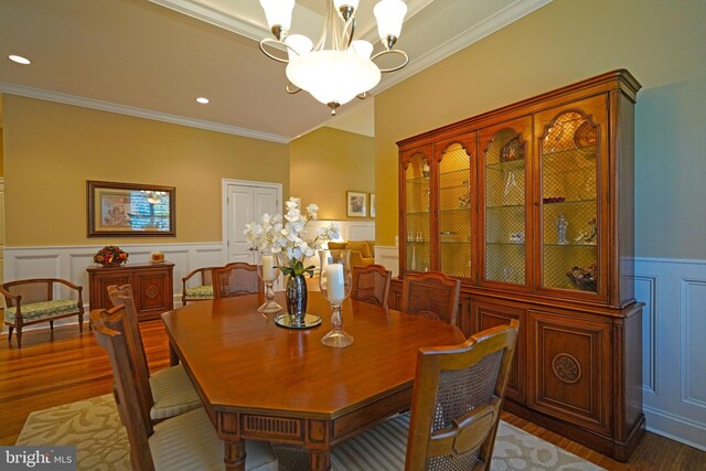322 Captains Cir, Lewes, DE 19958 - dining space featuring a decorative wall, ornamental molding, wood finished floors, a chandelier, and a wainscoted wall
