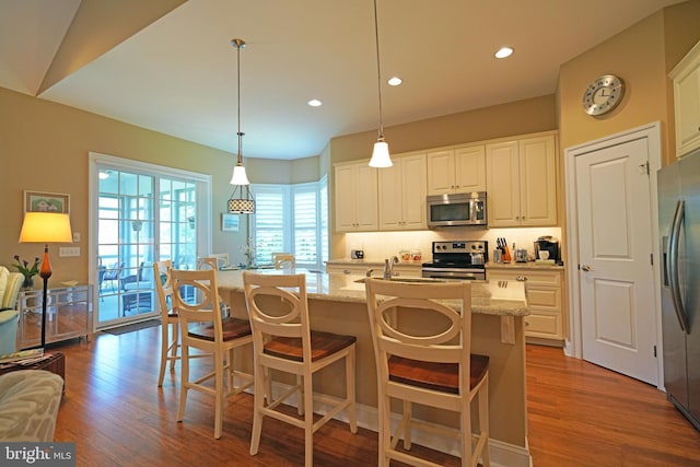 322 Captains Cir, Lewes, DE 19958 - kitchen with appliances with stainless steel finishes, dark wood finished floors, backsplash, light stone countertops, and recessed lighting