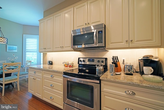 322 Captains Cir, Lewes, DE 19958 - kitchen with stainless steel appliances, backsplash, dark wood finished floors, and light stone counters