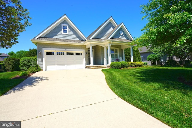 322 Captains Cir, Lewes, DE 19958 - view of front of property featuring concrete driveway, a porch, a front lawn, and an attached garage