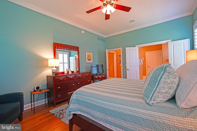 322 Captains Cir, Lewes, DE 19958 - bedroom with wood finished floors, crown molding, baseboards, and a ceiling fan