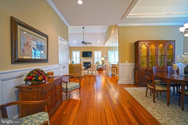 322 Captains Cir, Lewes, DE 19958 - foyer entrance featuring a fireplace, ornamental molding, a wainscoted wall, wood finished floors, and ceiling fan