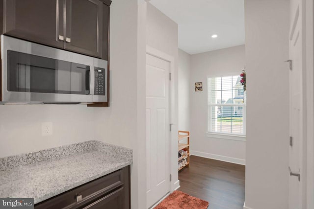 2005 Benjamin Ct, Harrisburg, PA 17110 - kitchen with stainless steel microwave, dark wood-style flooring, dark brown cabinets, light stone counters, and recessed lighting