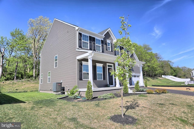 2005 Benjamin Ct, Harrisburg, PA 17110 - view of side of home featuring a porch, a lawn, and a garage
