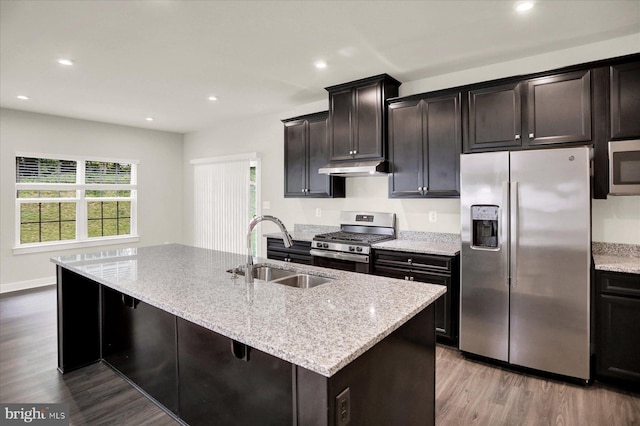 2005 Benjamin Ct, Harrisburg, PA 17110 - kitchen featuring stainless steel appliances, wood finished floors, light stone countertops, a kitchen island with sink, and recessed lighting