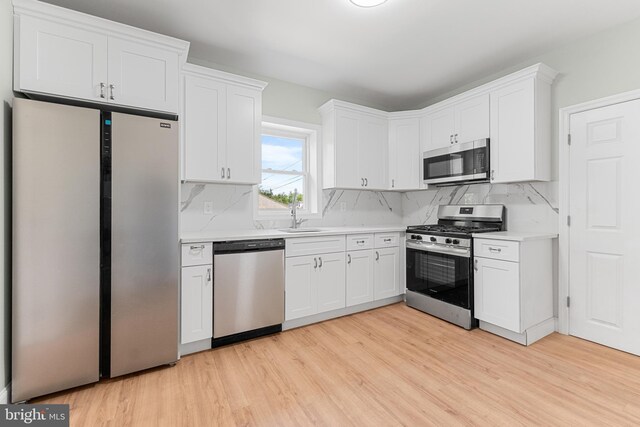 503 W Park Ave, Hamilton, NJ 08610 - kitchen featuring stainless steel appliances, light wood finished floors, light countertops, and decorative backsplash