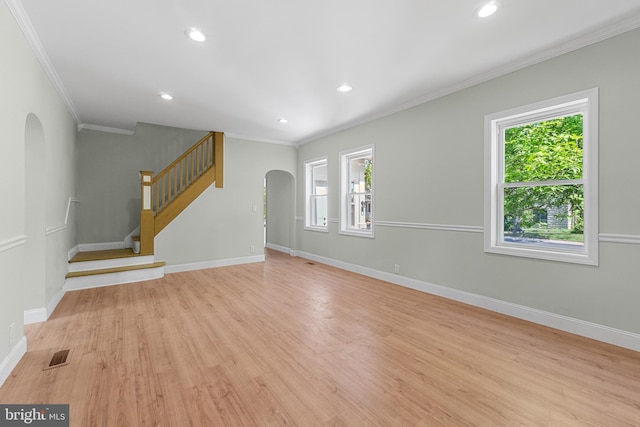 503 W Park Ave, Hamilton, NJ 08610 - unfurnished living room with arched walkways, ornamental molding, healthy amount of natural light, light wood-style flooring, and baseboards