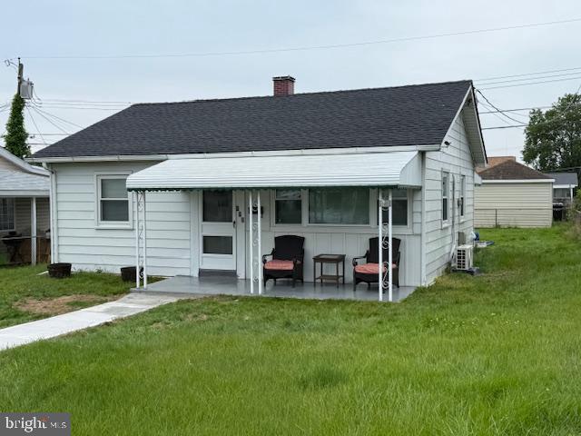 112 Dihedral Dr, Baltimore, MD 21220 - back of house with roof with shingles, a yard, a chimney, and cooling unit