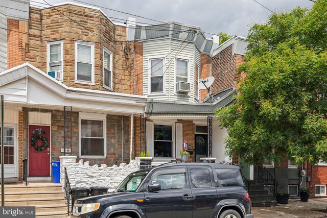 3164 Cedar St, Philadelphia, PA 19134 - view of property with stone siding, a porch, and cooling unit
