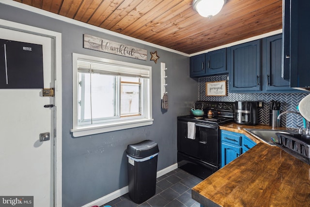 3164 Cedar St, Philadelphia, PA 19134 - kitchen with black electric range, butcher block countertops, blue cabinetry, decorative backsplash, and dark tile patterned flooring