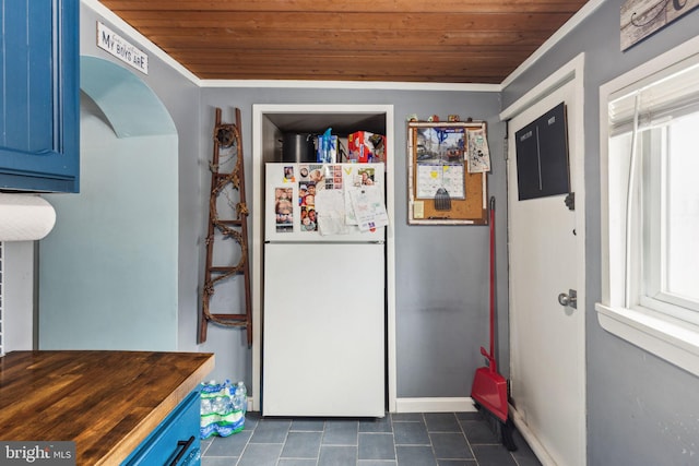 3164 Cedar St, Philadelphia, PA 19134 - kitchen featuring freestanding refrigerator, wooden ceiling, blue cabinetry, healthy amount of natural light, and dark tile patterned floors
