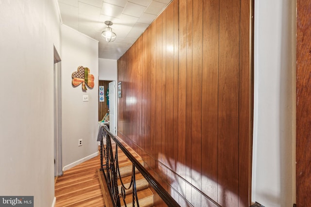 3164 Cedar St, Philadelphia, PA 19134 - hall with an upstairs landing, wood walls, light wood-style flooring, and baseboards