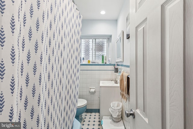 3164 Cedar St, Philadelphia, PA 19134 - bathroom with vanity, toilet, tile walls, a shower with shower curtain, and a wainscoted wall