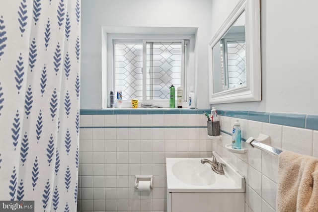3164 Cedar St, Philadelphia, PA 19134 - bathroom featuring tile walls, vanity, wainscoting, and a shower with curtain