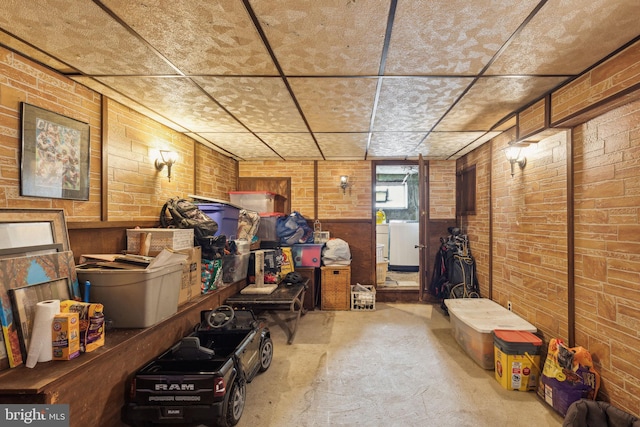 3164 Cedar St, Philadelphia, PA 19134 - basement with washer / dryer, brick wall, a paneled ceiling, and wood walls