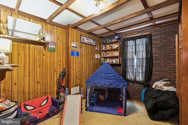 3164 Cedar St, Philadelphia, PA 19134 - recreation room featuring wooden walls, carpet flooring, beamed ceiling, and brick wall