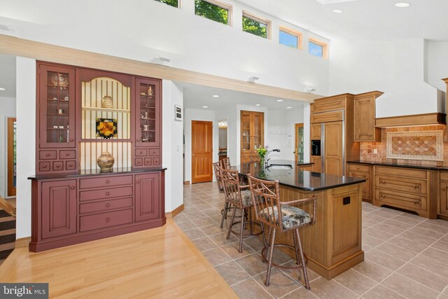 511 Center Hl, Upper Black Eddy, PA 18972 - kitchen with dark countertops, paneled refrigerator, a sink, backsplash, and glass insert cabinets