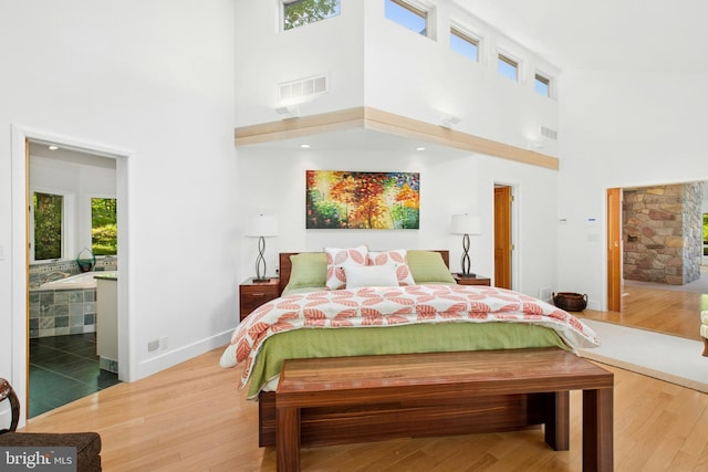 511 Center Hl, Upper Black Eddy, PA 18972 - bedroom featuring a towering ceiling, wood finished floors, baseboards, and ensuite bath