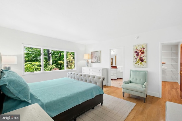 511 Center Hl, Upper Black Eddy, PA 18972 - bedroom with light wood-style floors, baseboards, and ensuite bath
