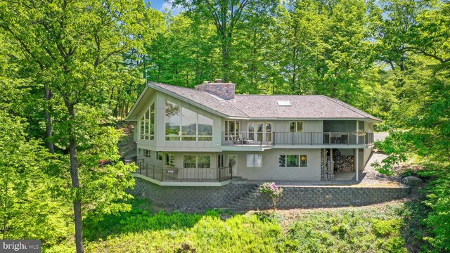 511 Center Hl, Upper Black Eddy, PA 18972 - rear view of property with stairs, a chimney, a shingled roof, and a patio area